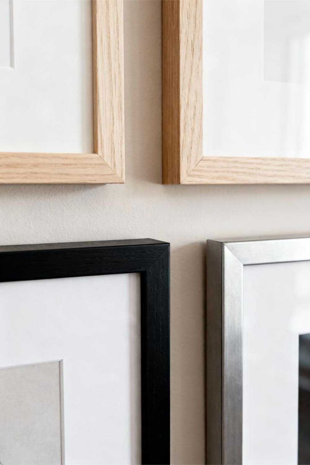 Minimalist frames displayed on a gallery wall with clean, simple styling.