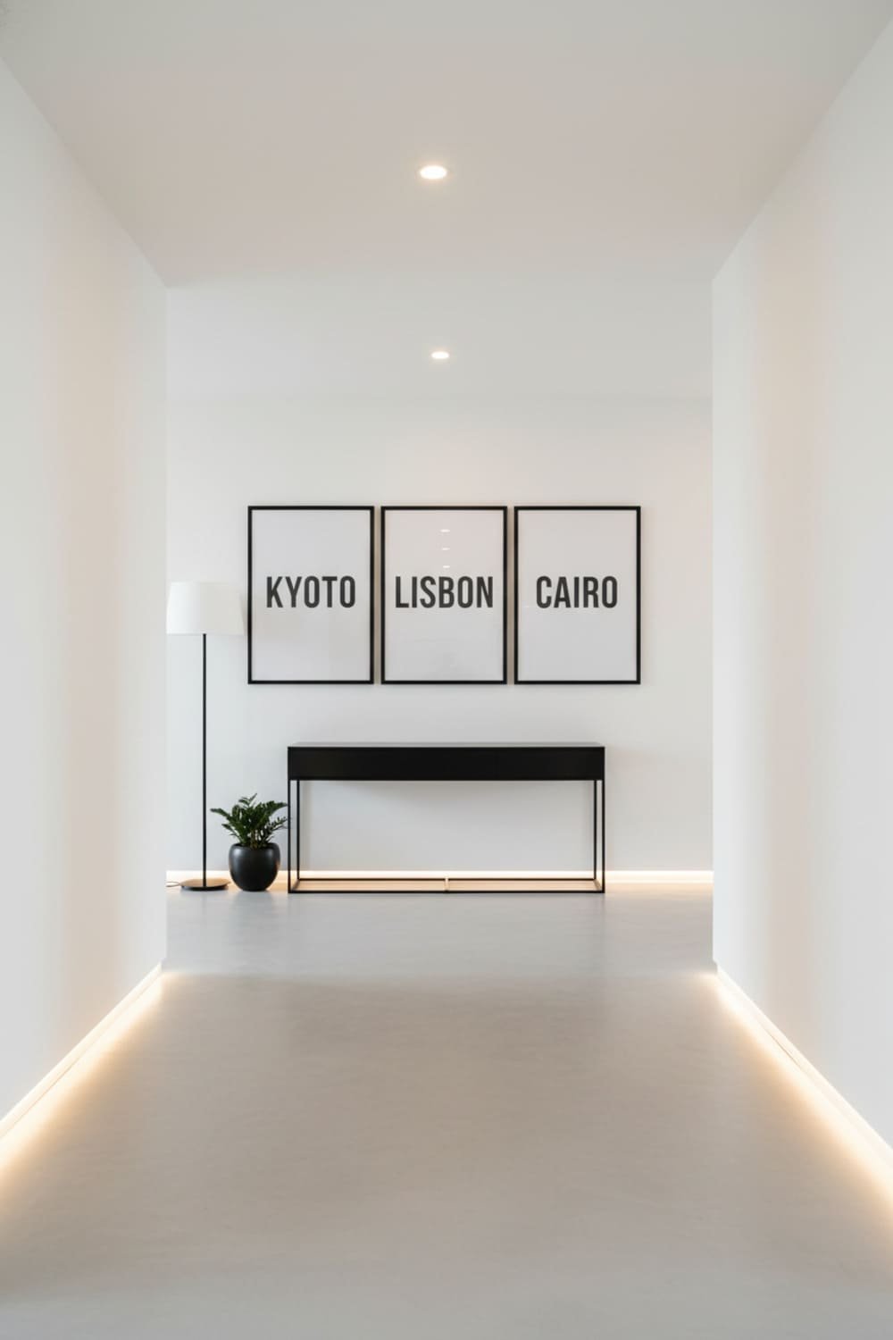 Black-and-white city name typography printables arranged in a triptych layout in a minimalist hallway.
