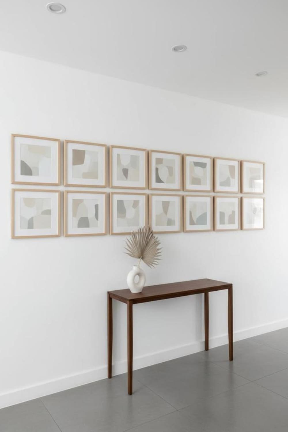 Minimalist hallway gallery wall with evenly spaced matching frames