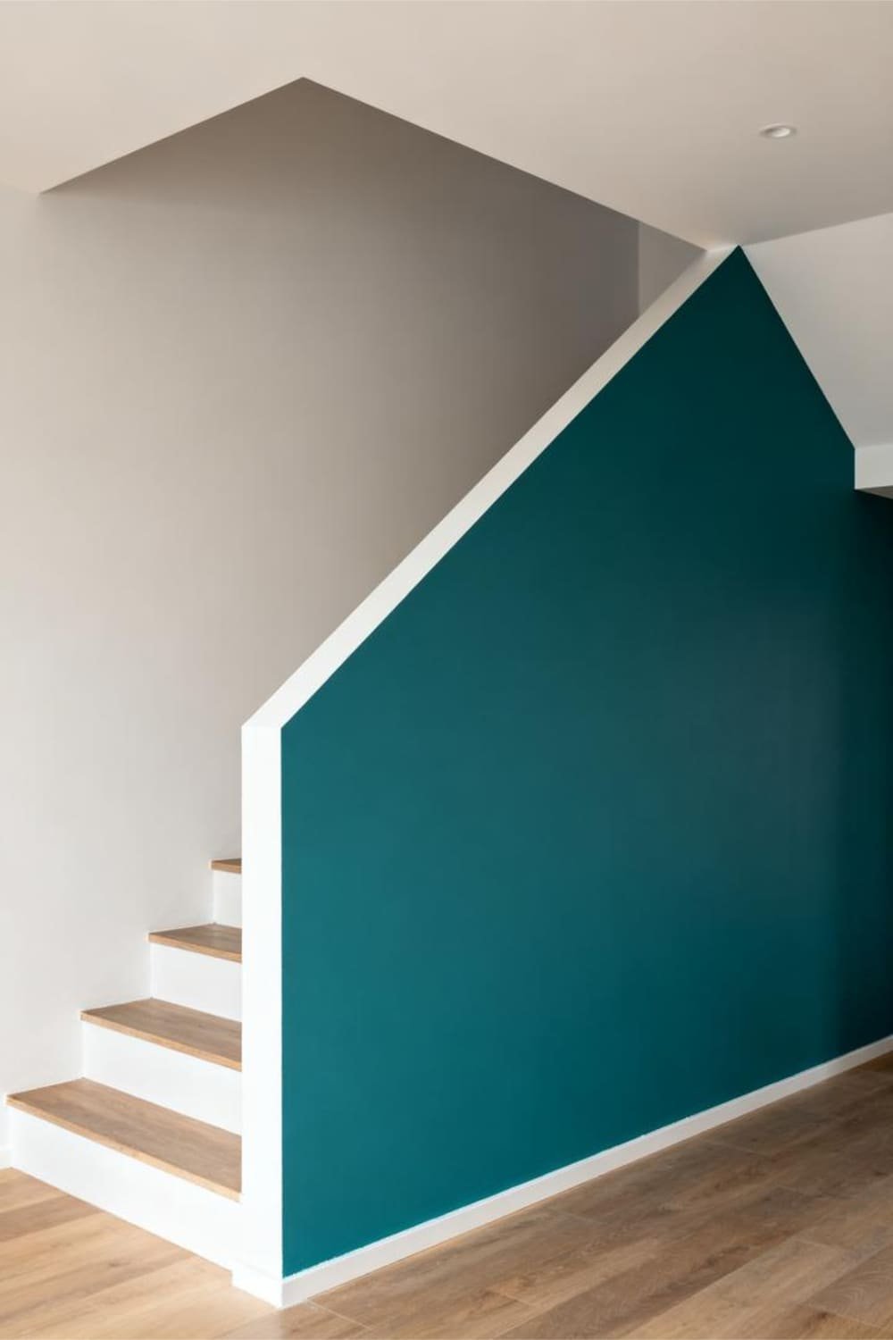 Angular painted accent design under the stairs creating a bold geometric look.